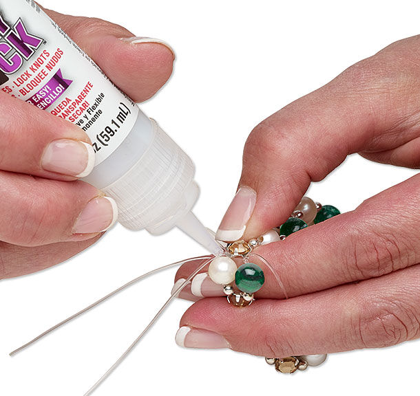 Adhesive being applied to knotted cord